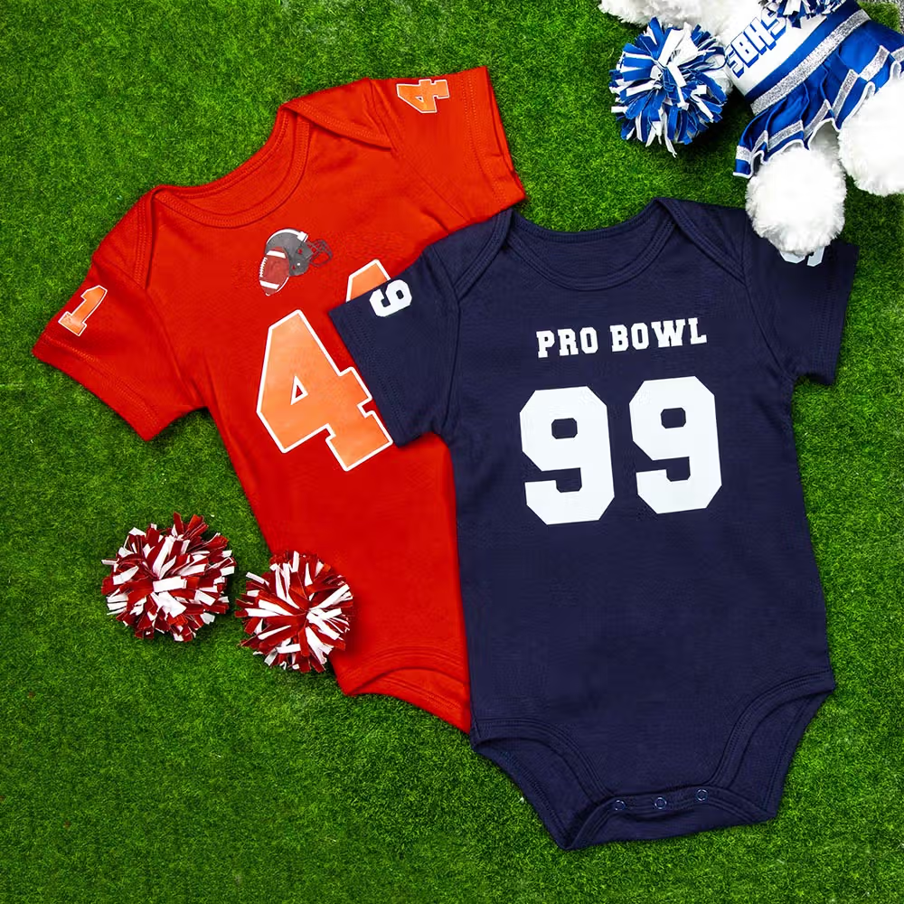 Klä familjens nykomling i matchkläder med en personlig sporttröja med fotbollsdesign och namn till baby